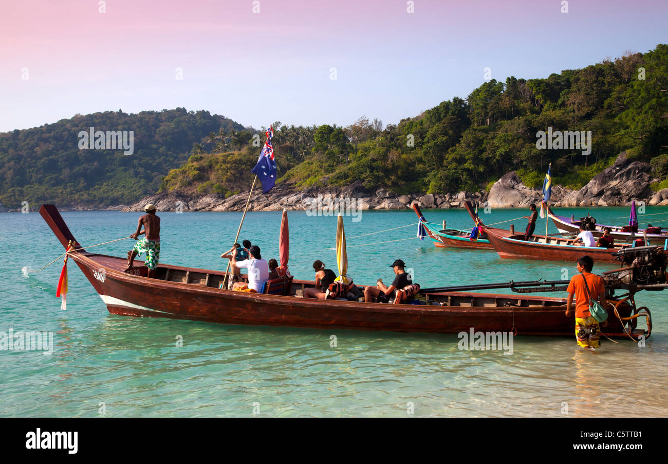 Longtail Boats Anchored Along Freedom Beach And Passengers