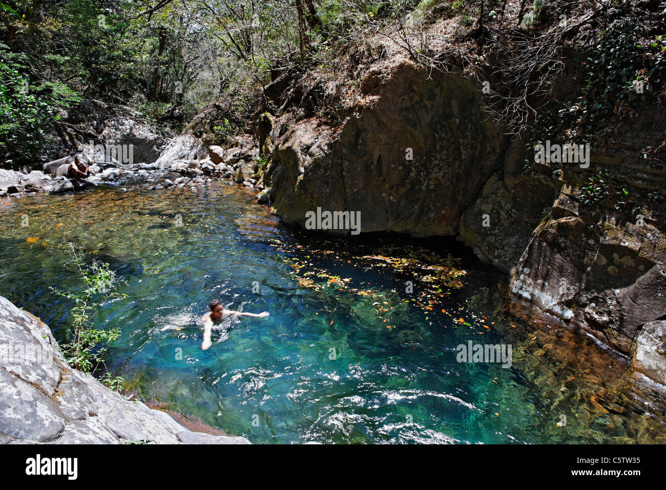 Costa Rica, Guanacaste, Rincon de la Vieja National Park, Tourists bathing in stream Stock Photo