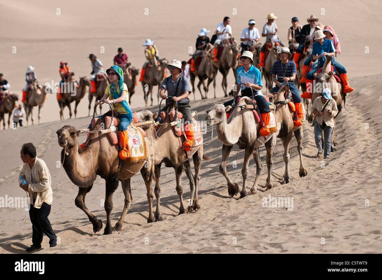 Chinese man in traditional dress on camel hi-res stock photography and ...