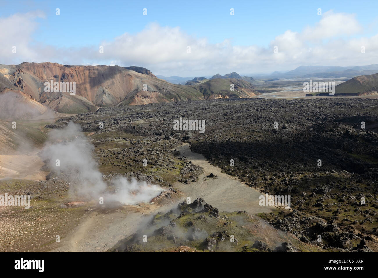 Old Lava Flow with Steam Rising from Fumeroles on the Laugavegur Hiking Trail Near Landmannalaugar Fjallabak Area of Iceland Stock Photo