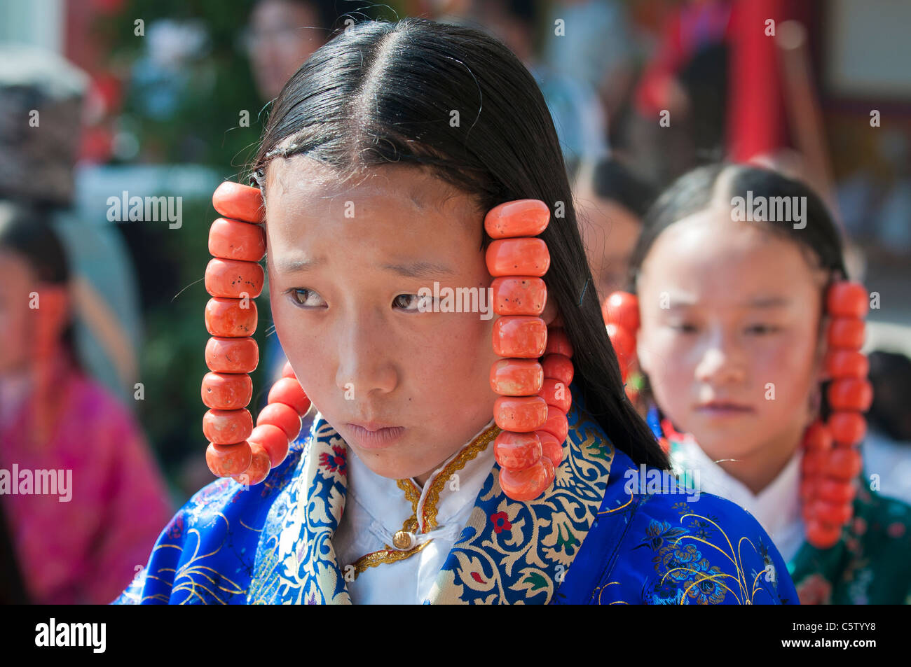 Young girls wearing heavy coral jewelry perform at shaman harvest