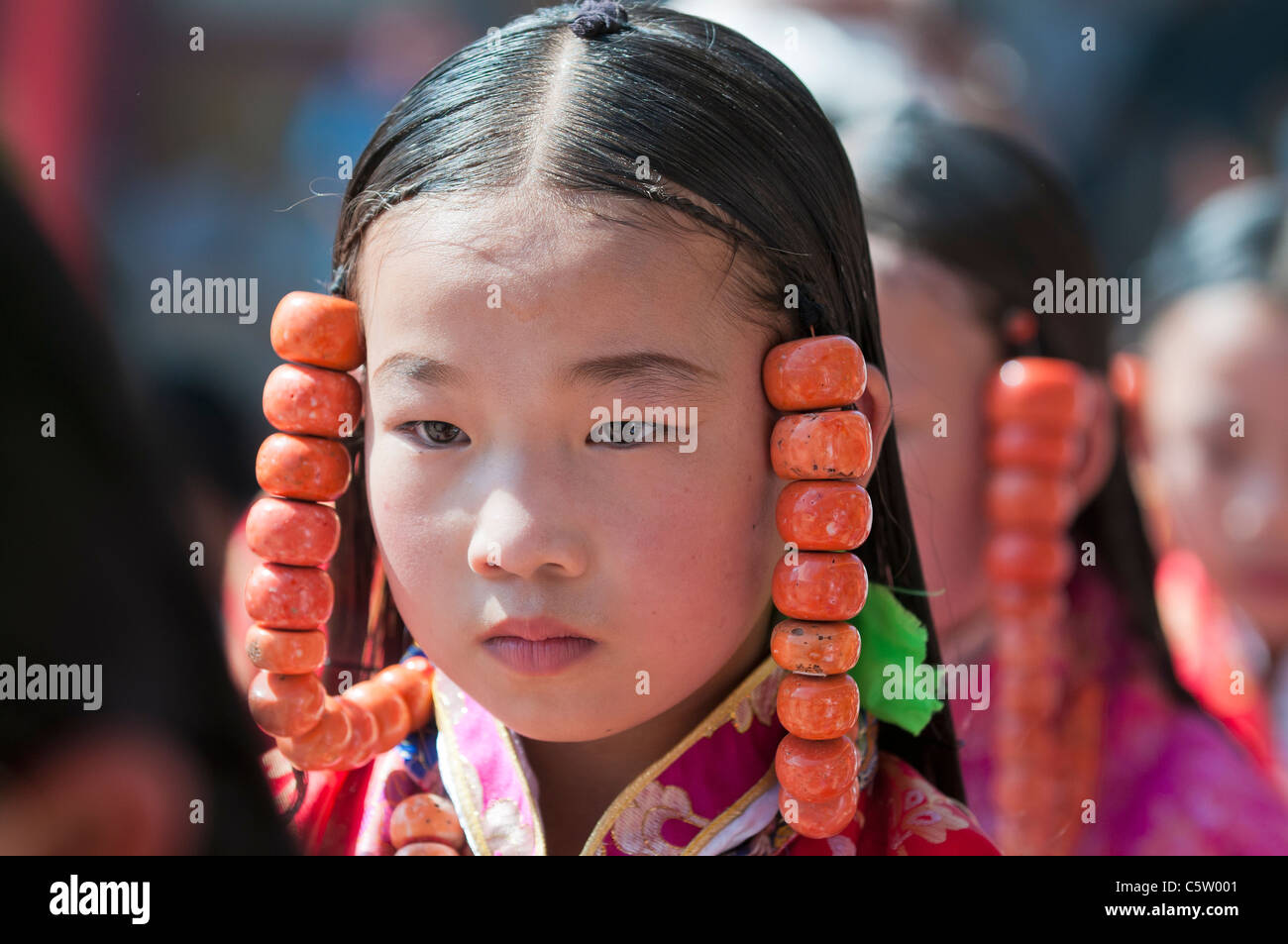 Young girls wearing heavy coral jewelry perform at shaman harvest