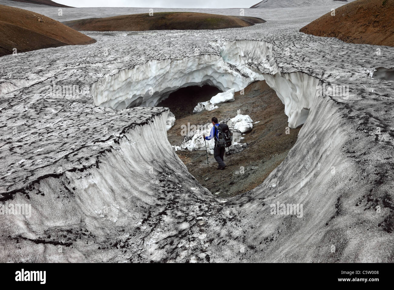 Trekker Safely Exploring a Collapsed Ice Cave on the Laugavegur Hiking Trail Iceland Stock Photo