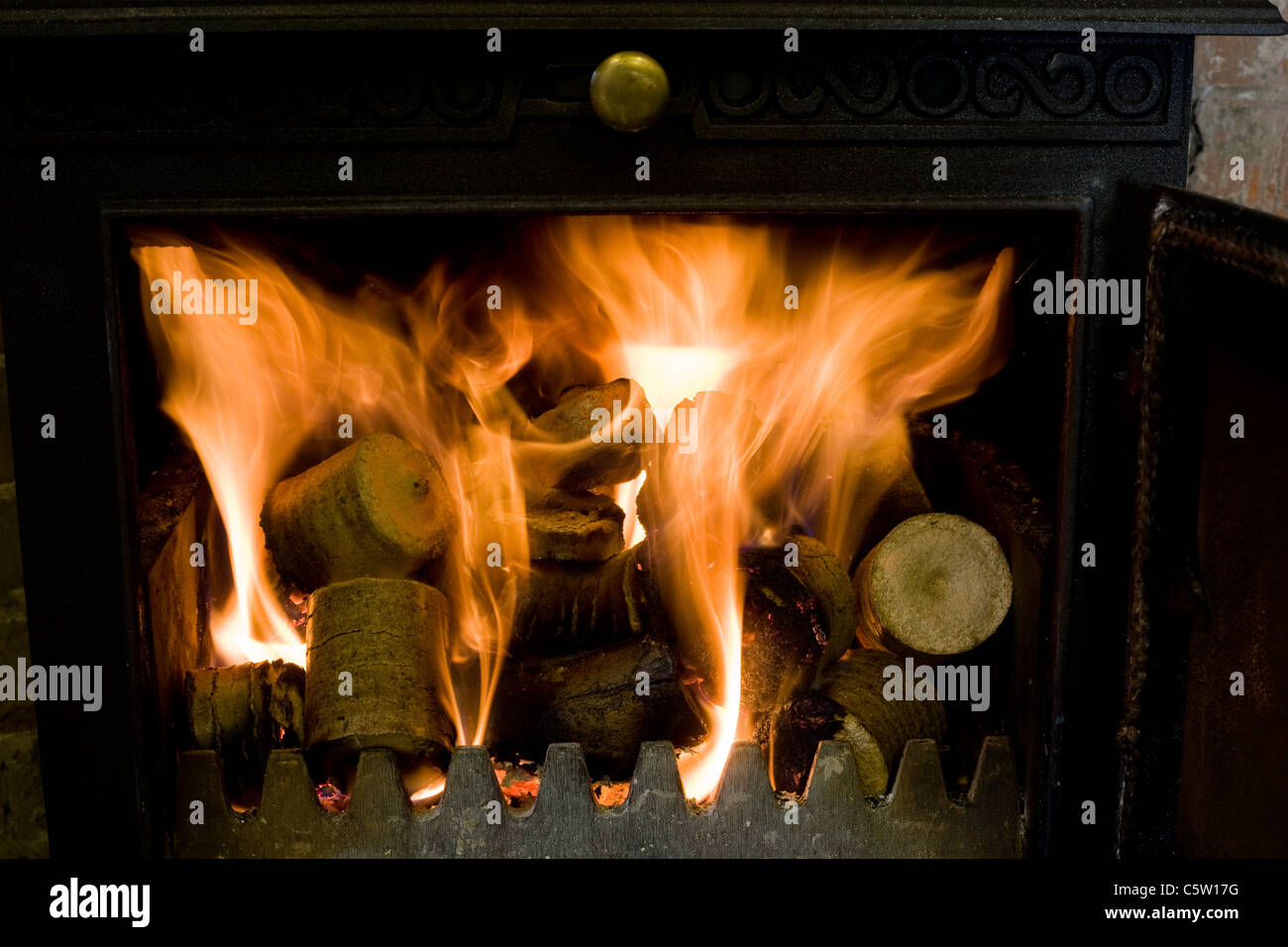 Compressed wood chip and sawdust pellets in a log basket, ready to
