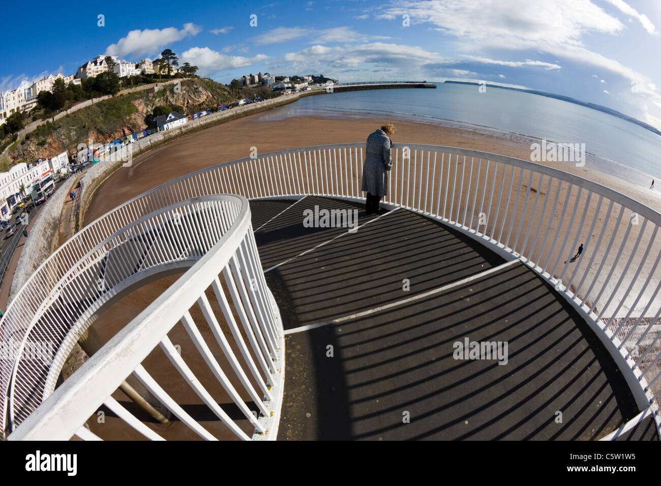 Metal bridge and railings with spiral staircase leading down to the beach in Torquay, Devon Stock Photo