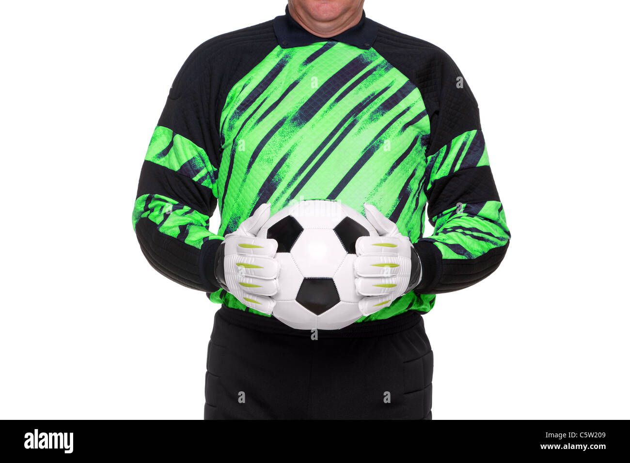 Photo of a football or soccer goalkeeper wearing gloves and holding a ball, isolated on a white background. Stock Photo