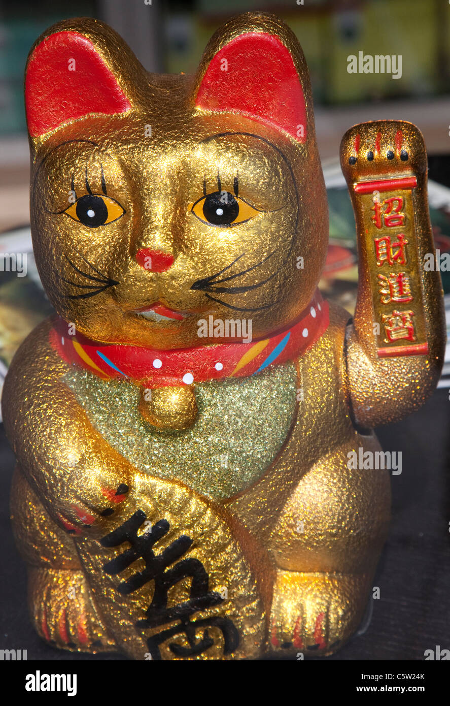 Japanese good fortune cat (Maneki Neko) in London shop window Stock Photo