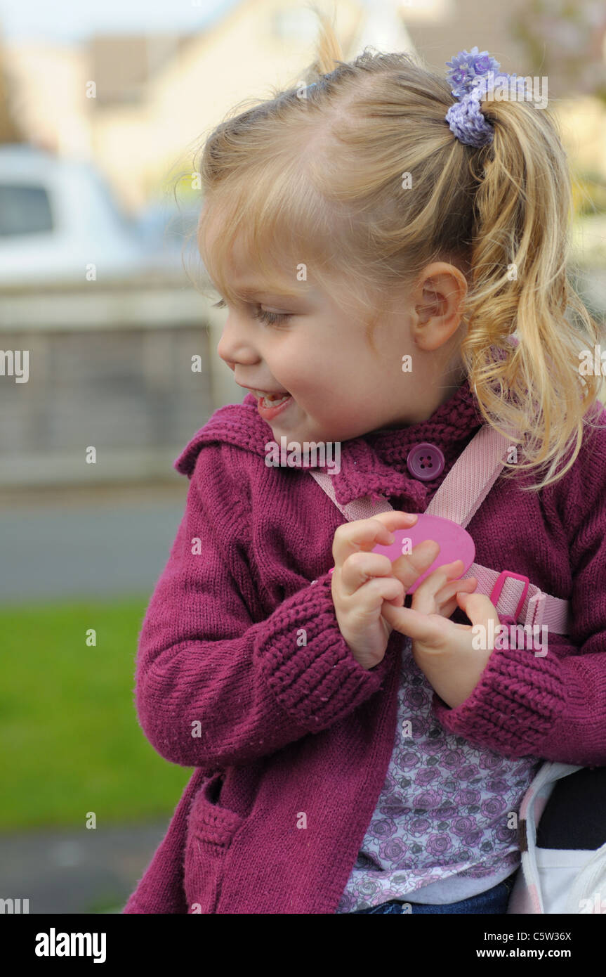 Little Girl With Hair In Bunches With Reins On Stock Photo