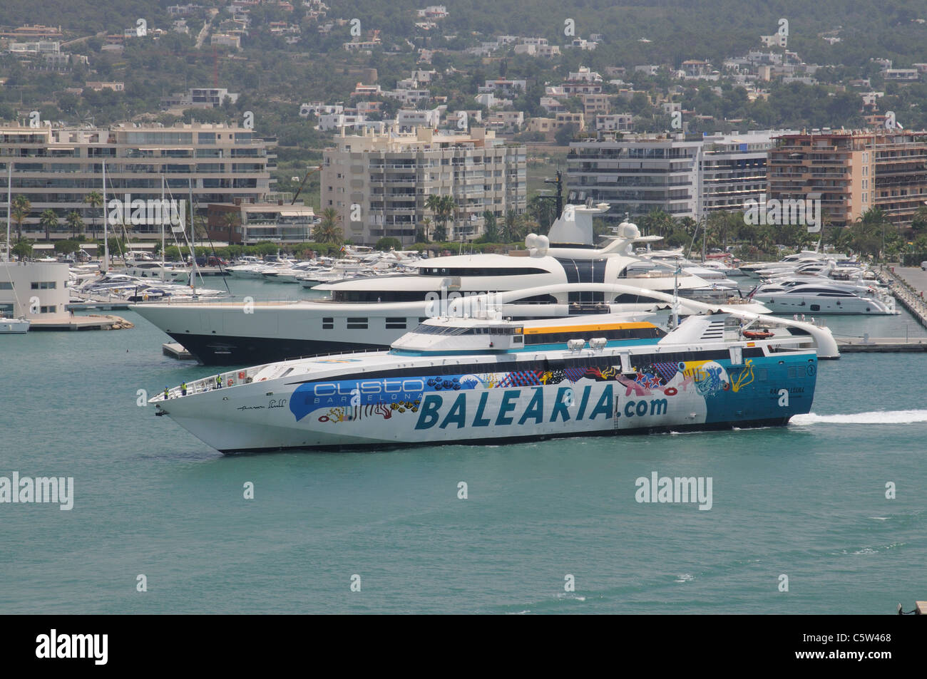 Harbour entrance at Eivissa port on the Spanish island of Ibiza Fast ferry Ramon Llull approaching the berth Stock Photo