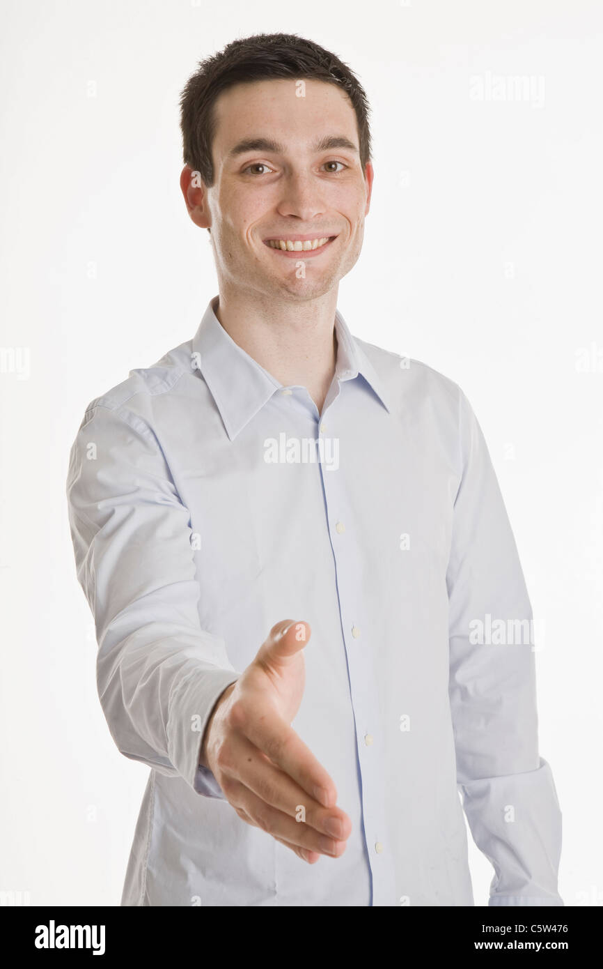 Businessman putting forth his his hand, smiling, portrait Stock Photo