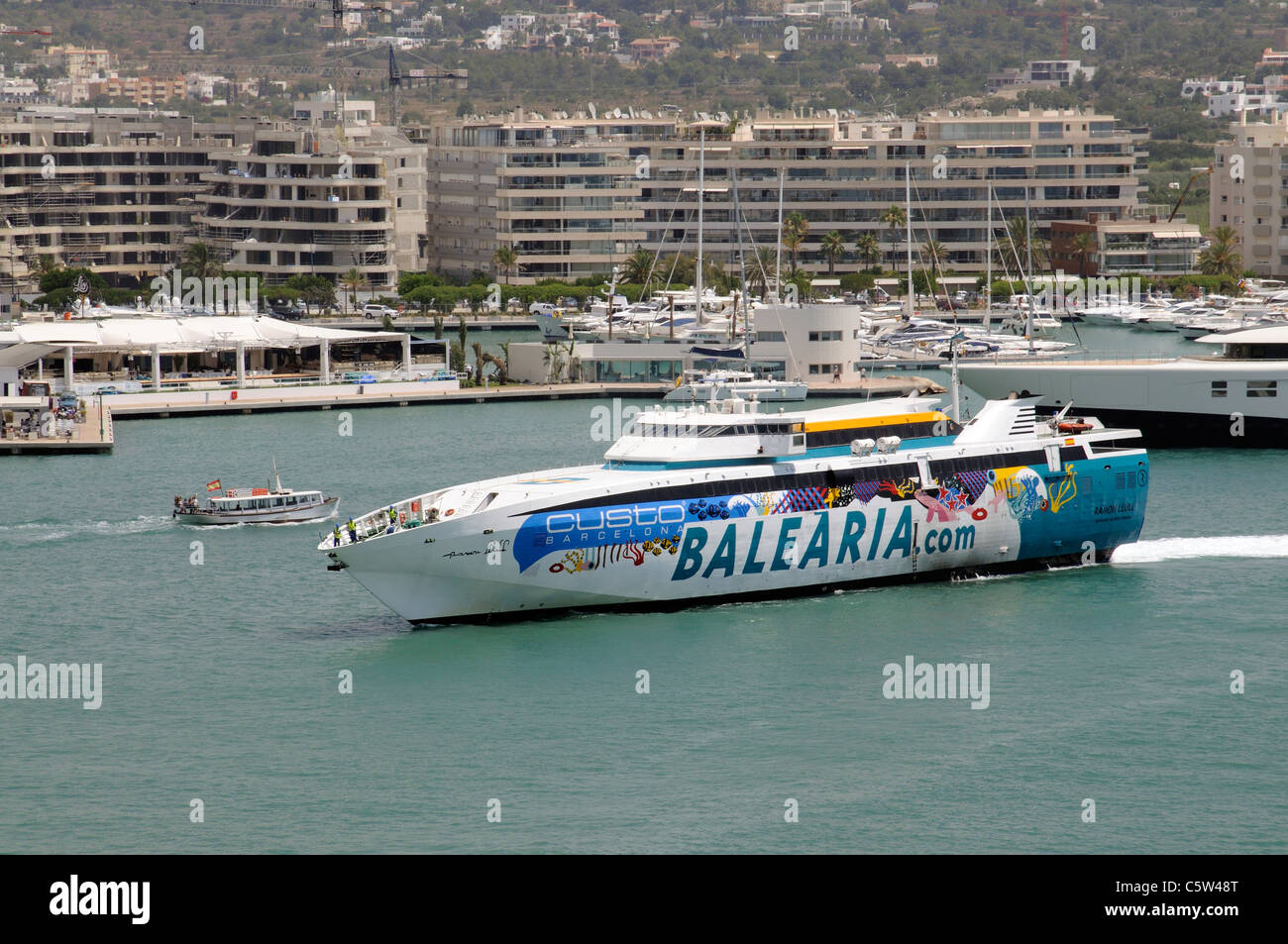 Harbour entrance at Eivissa port on the Spanish island of Ibiza Fast ferry Ramon Llull approaching the berth Stock Photo