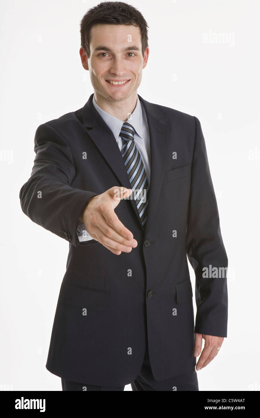Businessman putting forth his hand, smiling, portrait Stock Photo