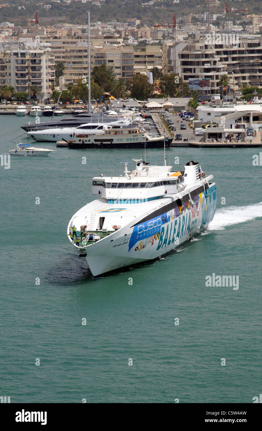 Harbour entrance at Eivissa port on the Spanish island of Ibiza Fast ferry Ramon Llull approaching the berth Stock Photo