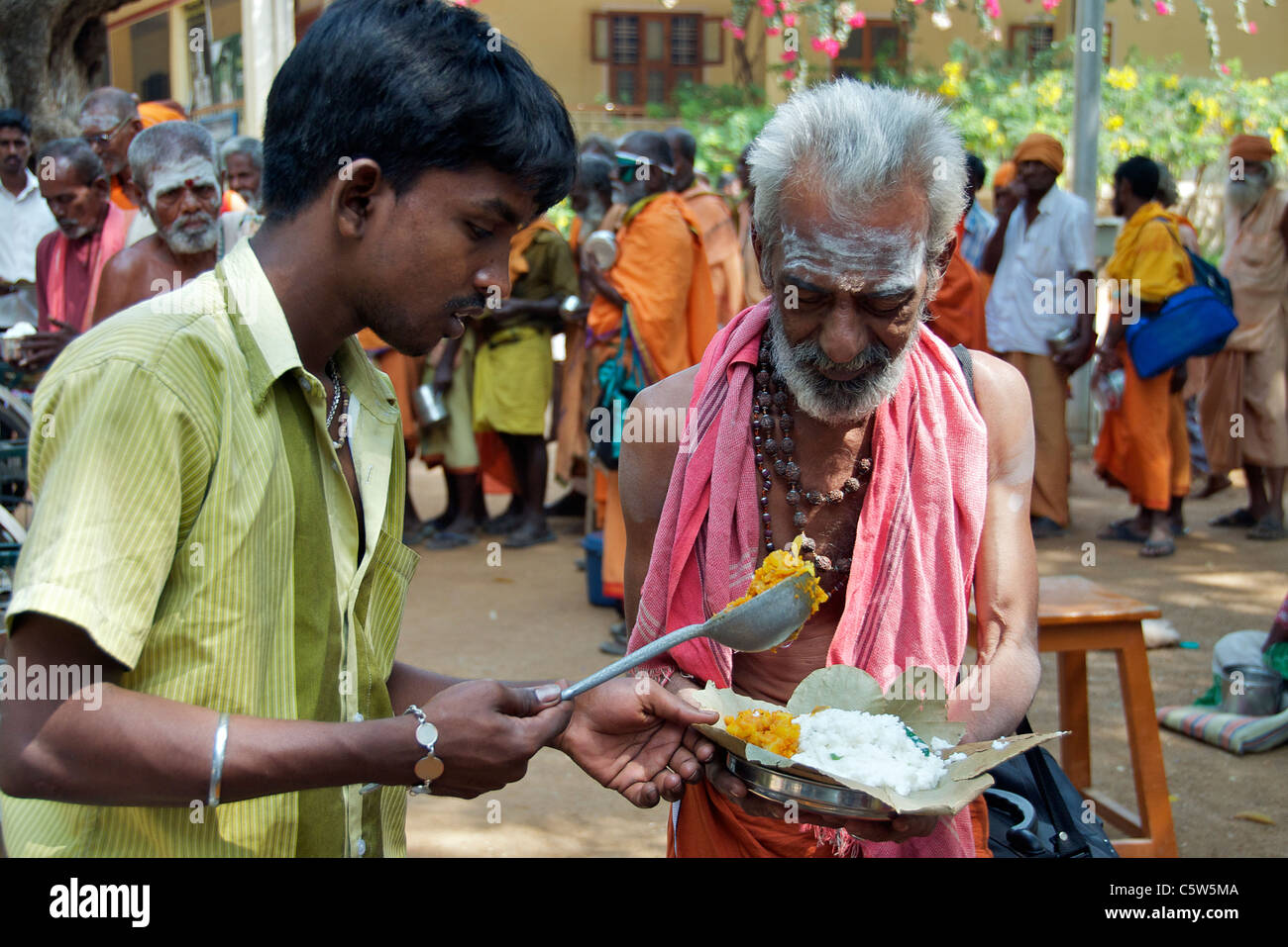 Sadu being served food Sri Ramana Ashram Tiruvannamalai Tamil Nadu South India Stock Photo