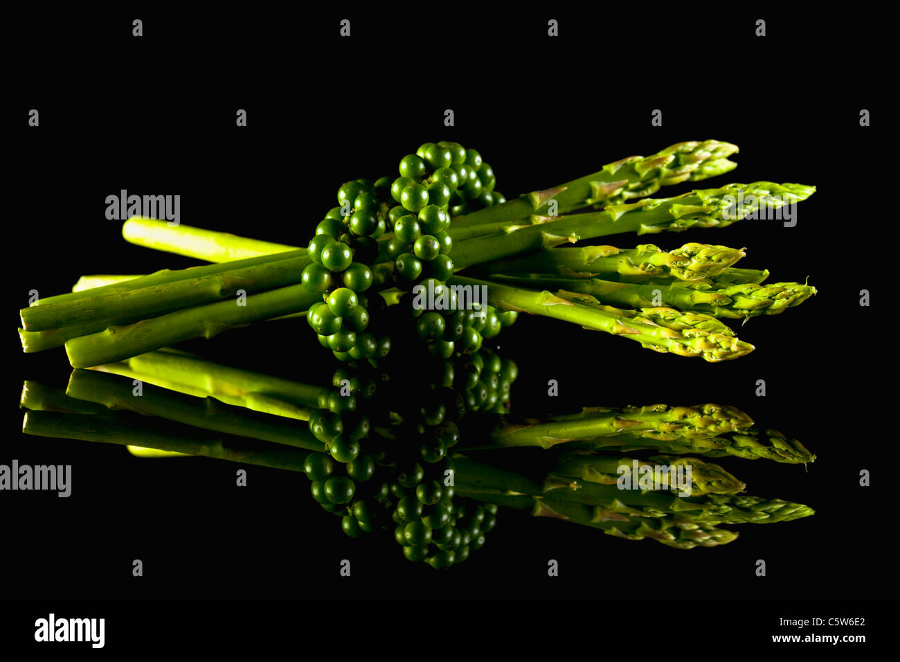 Green asparagus and green peppercorns (Piper nigrum Stock Photo