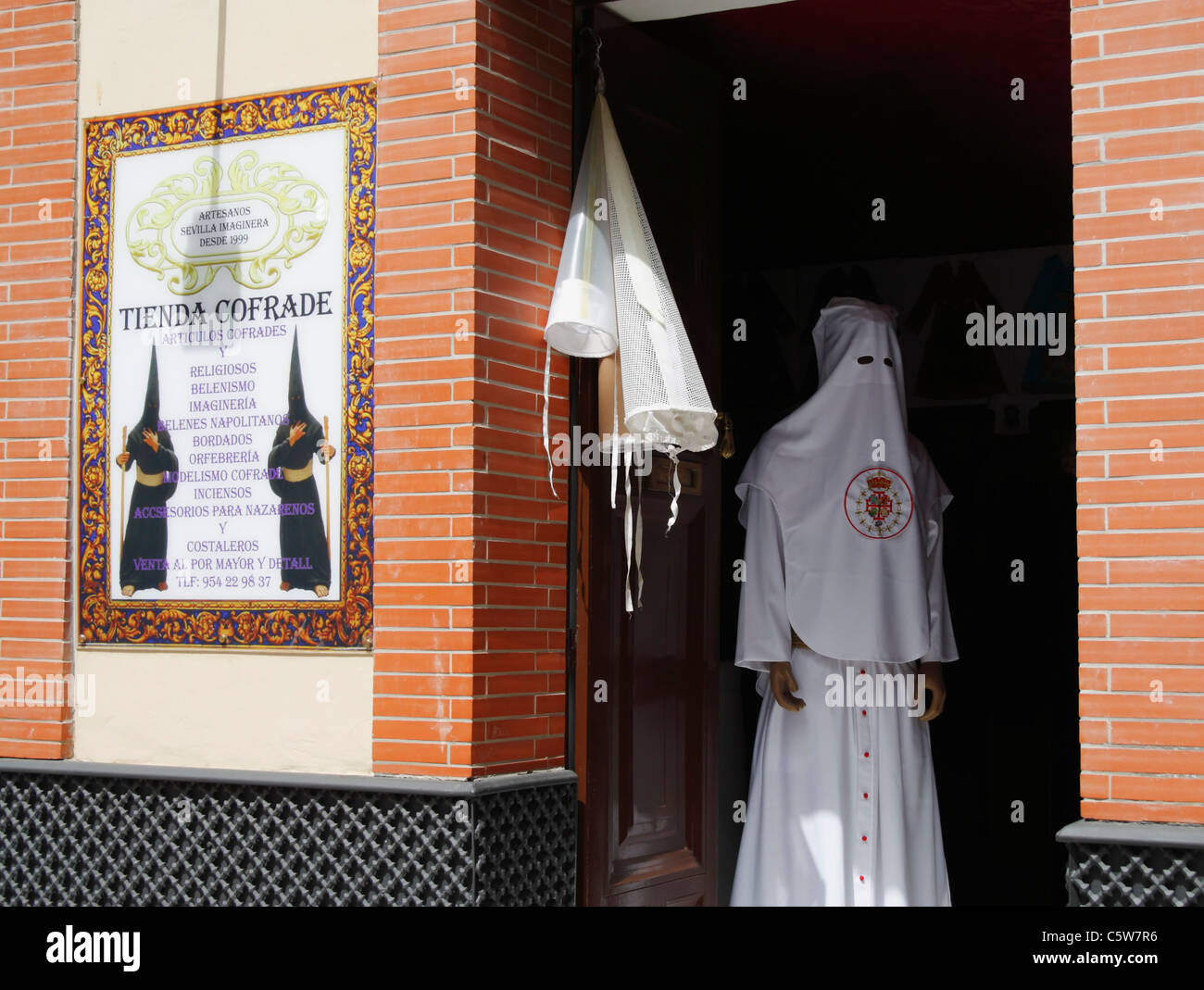 Cofrade shop in Seville selling robes and hats for Semana Santa processions. Andalusia, Spain Stock Photo