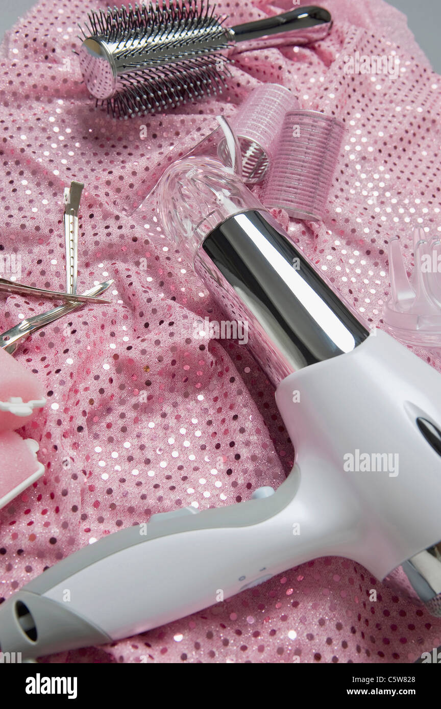 Hair dryer, hair clips curlers and hairbrush, elevated view Stock Photo