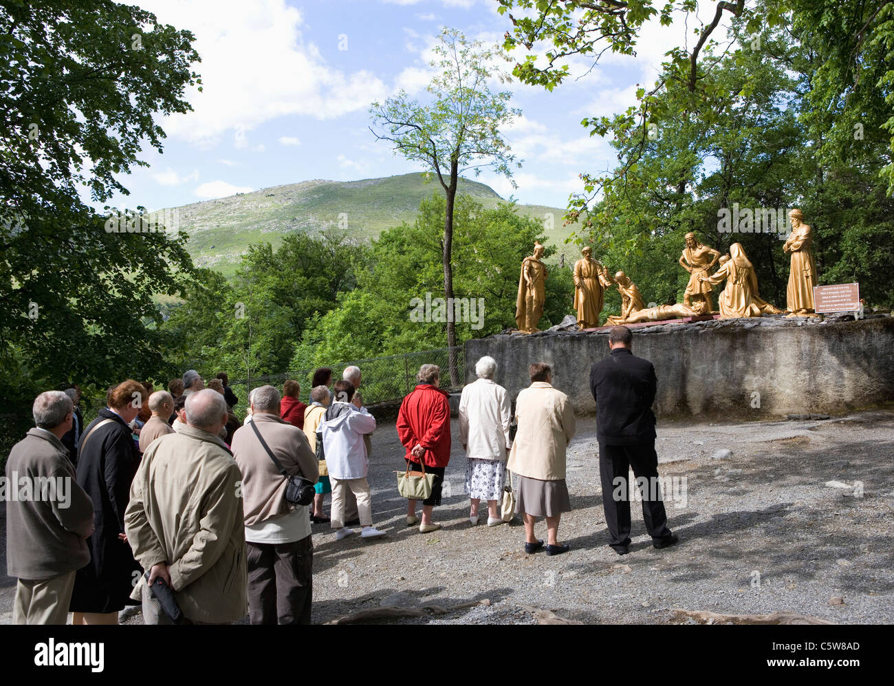 France, Lourdes, Via Crucis, Sculptures, Pilgrims watching Stock Photo