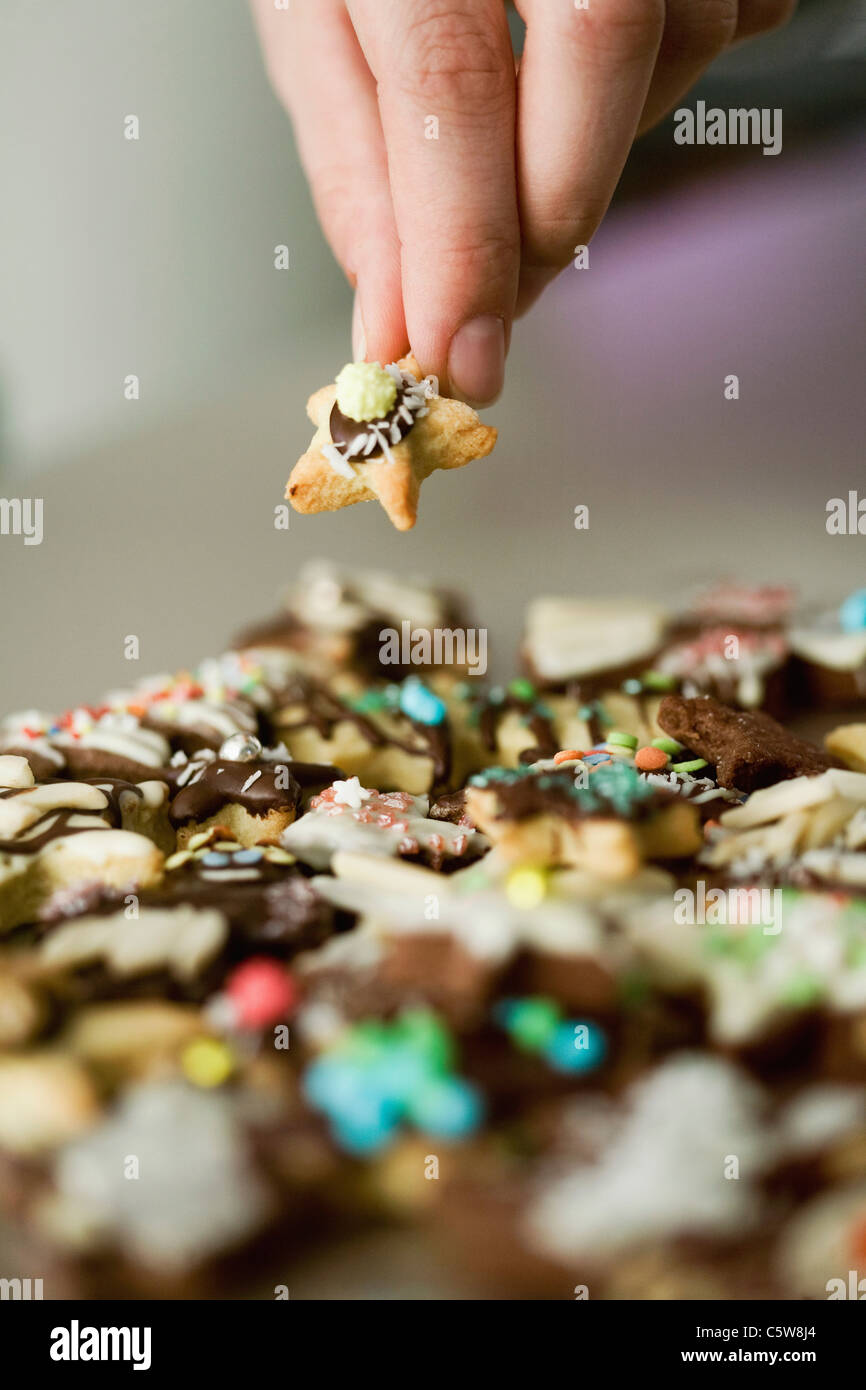 Christmas cookies, Hand holding cookie, close up Stock Photo