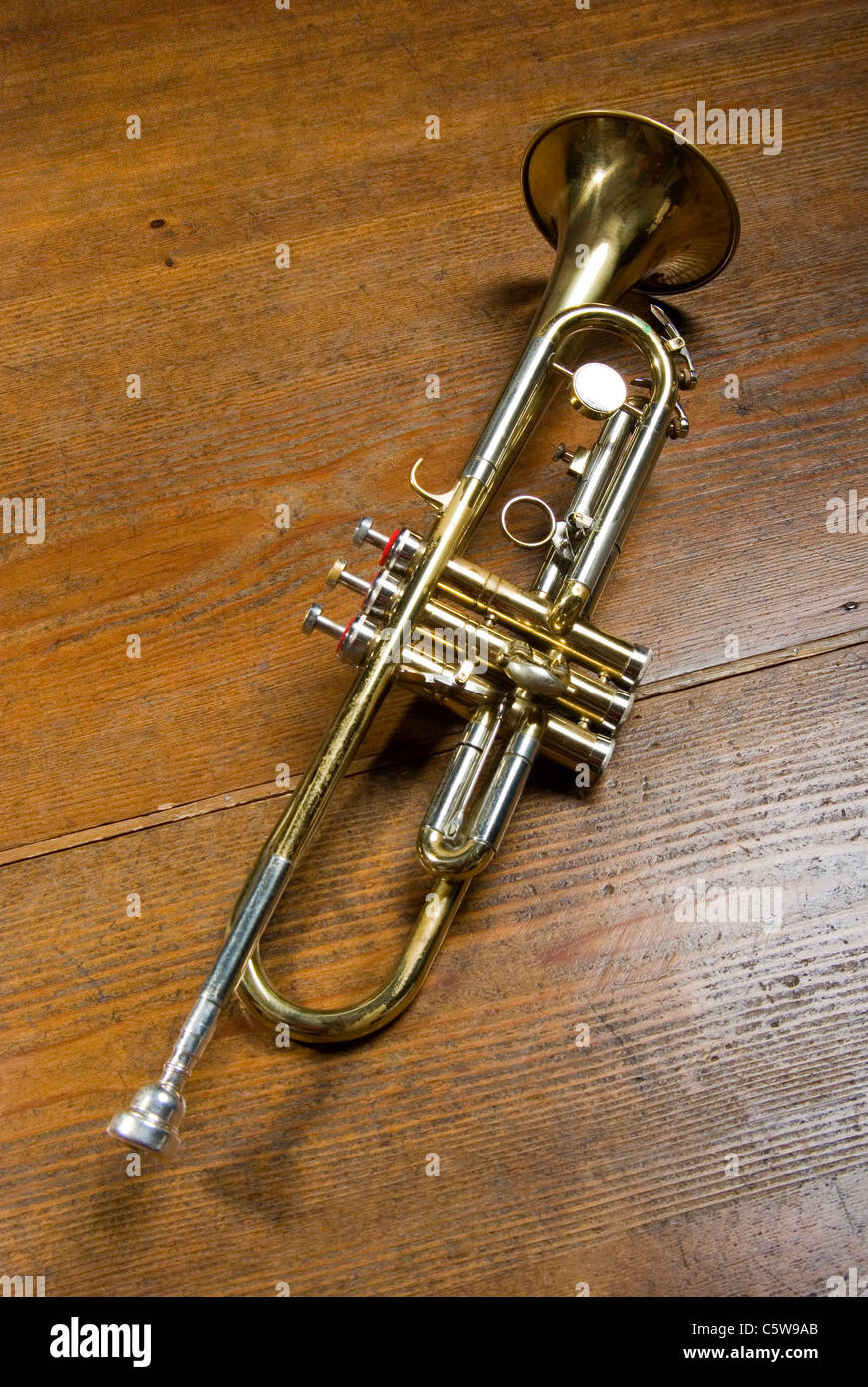 Trumpet on wooden floor, elevated view Stock Photo
