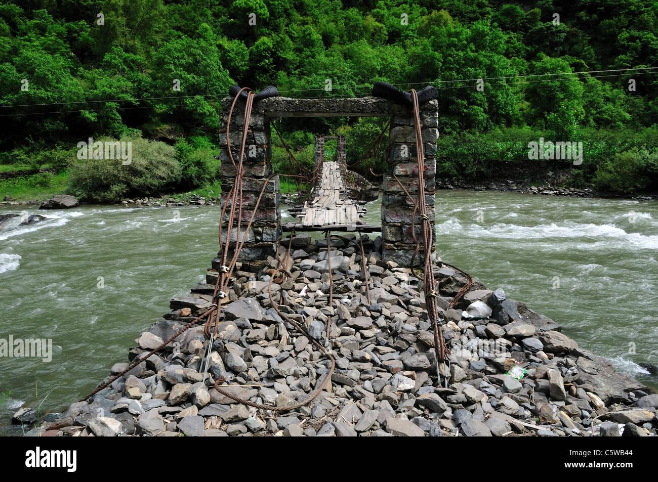 A hanging bridge over treacherous river. Sichuan, China. Stock Photo