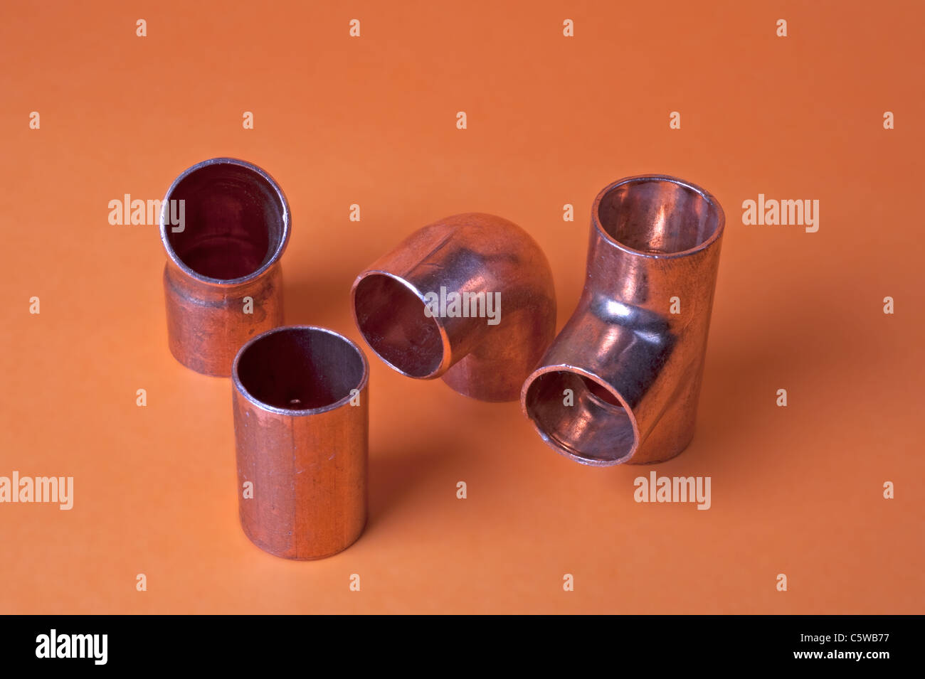 Close up of metal pipe fittings tee, bend, corner, and straight Stock Photo