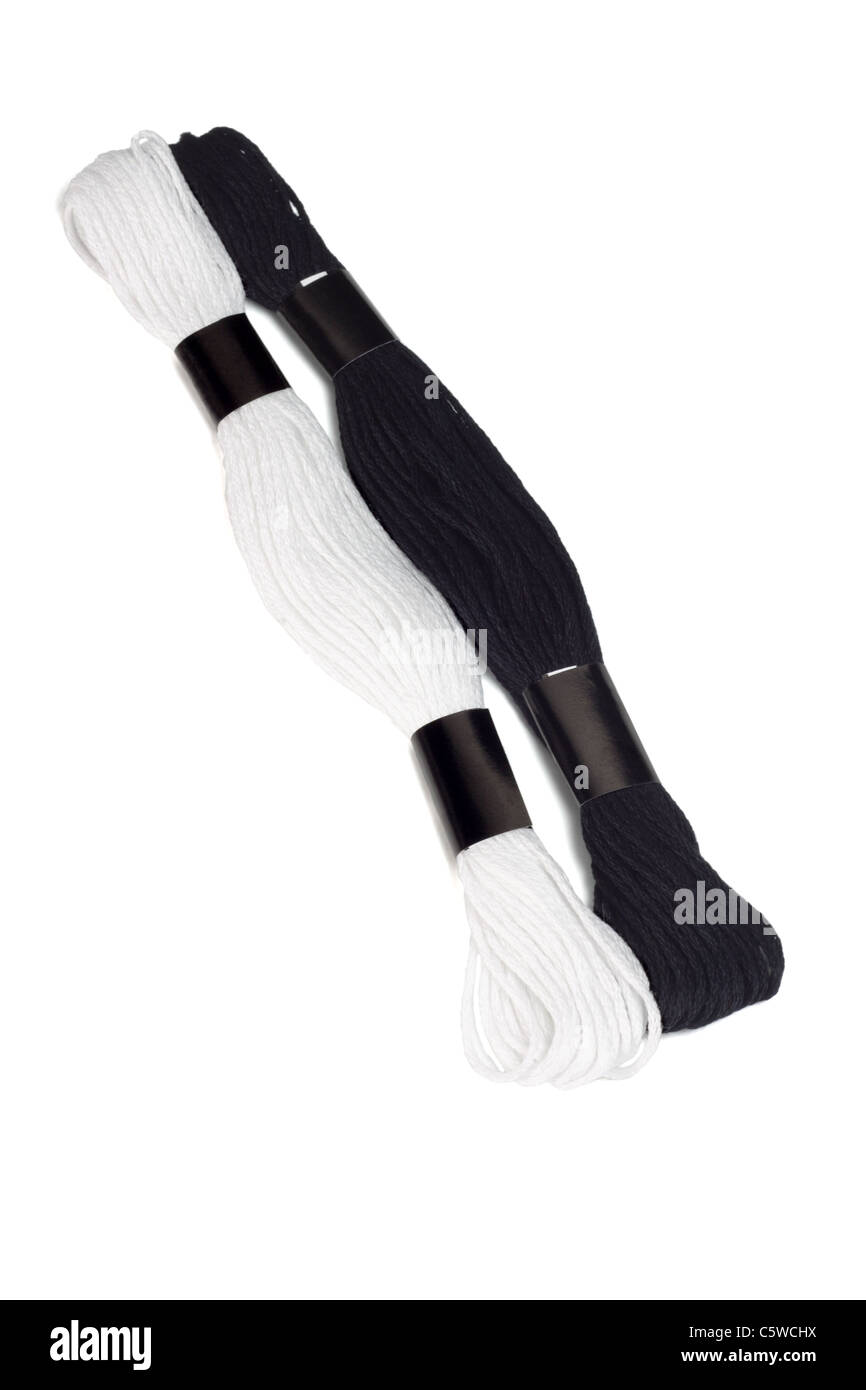 Black and white embroidery threads on isolated background Stock Photo
