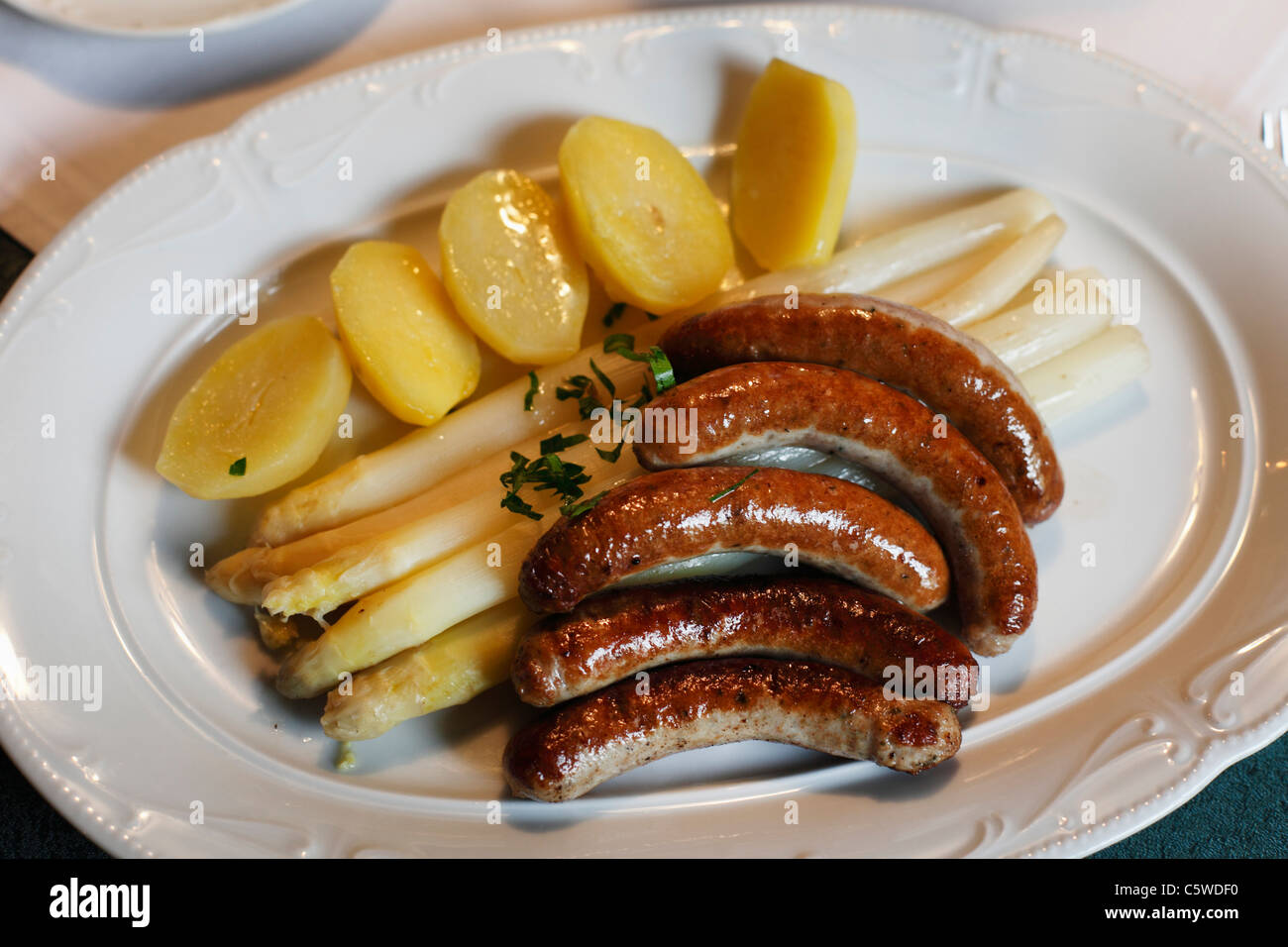 Germany, Bavaria, Franconia, Close up of fried sausages and asparagus Stock Photo