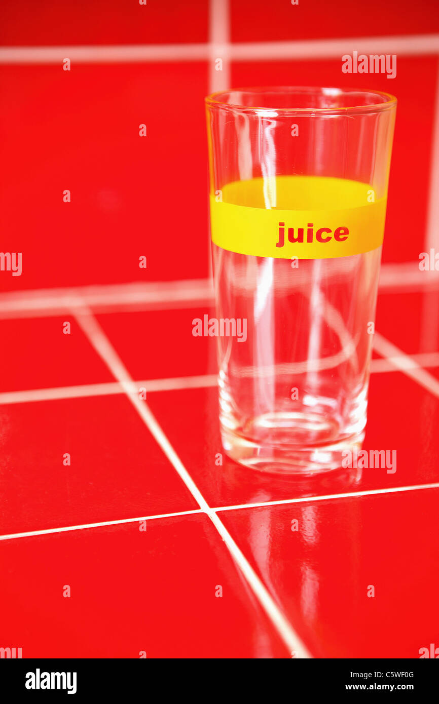Empty glass on red tiles Stock Photo