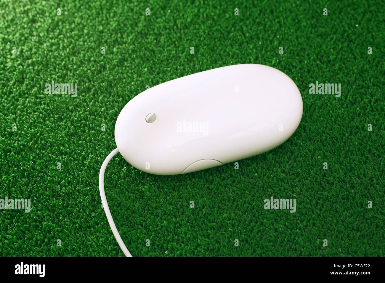 Computer mouse on green mouse pad, close up Stock Photo