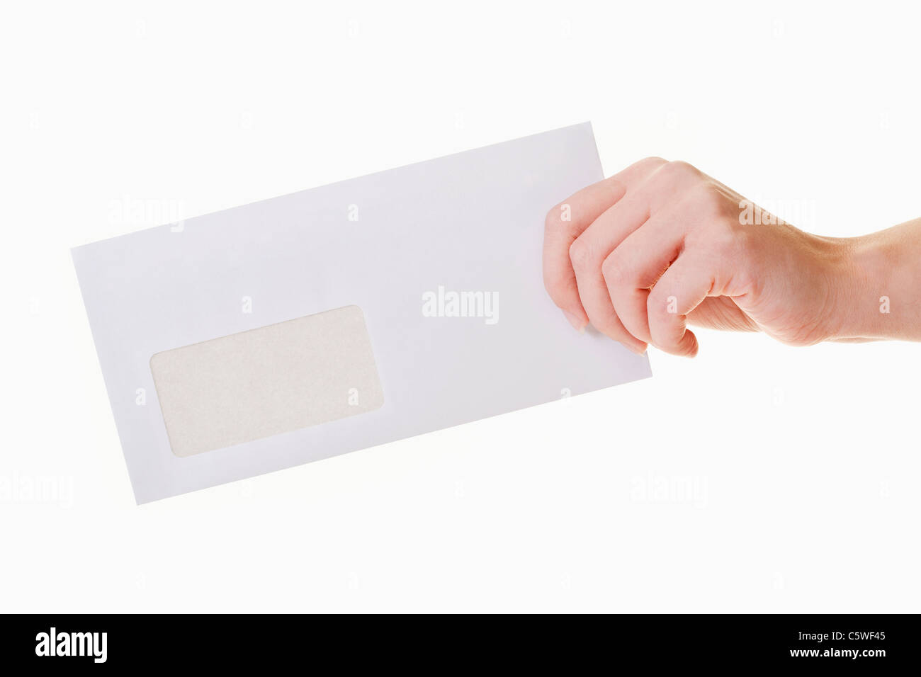 Hand of woman holding blank envelope against white background, close up Stock Photo