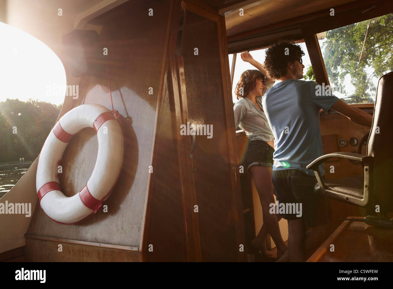 Germany, Berlin, Young couple in boat cabin Stock Photo