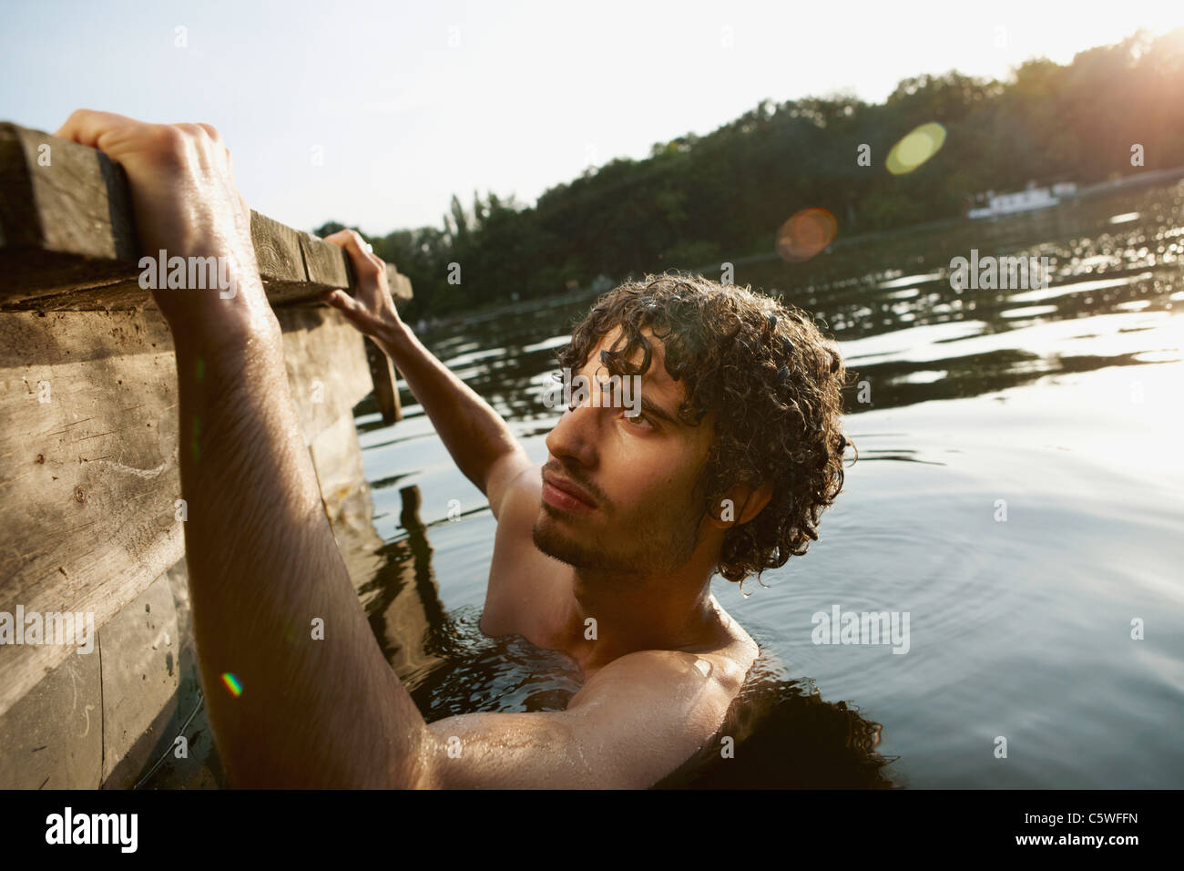 Germany, Berlin, Young man in Spree river, side view Stock Photo