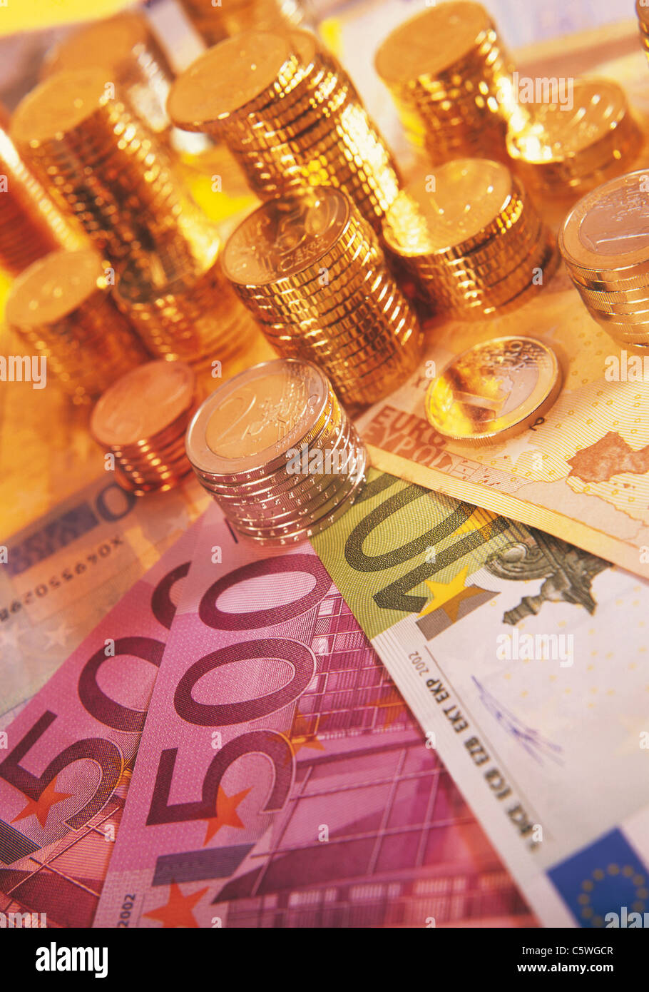 Close up of euro notes and stack of coins Stock Photo