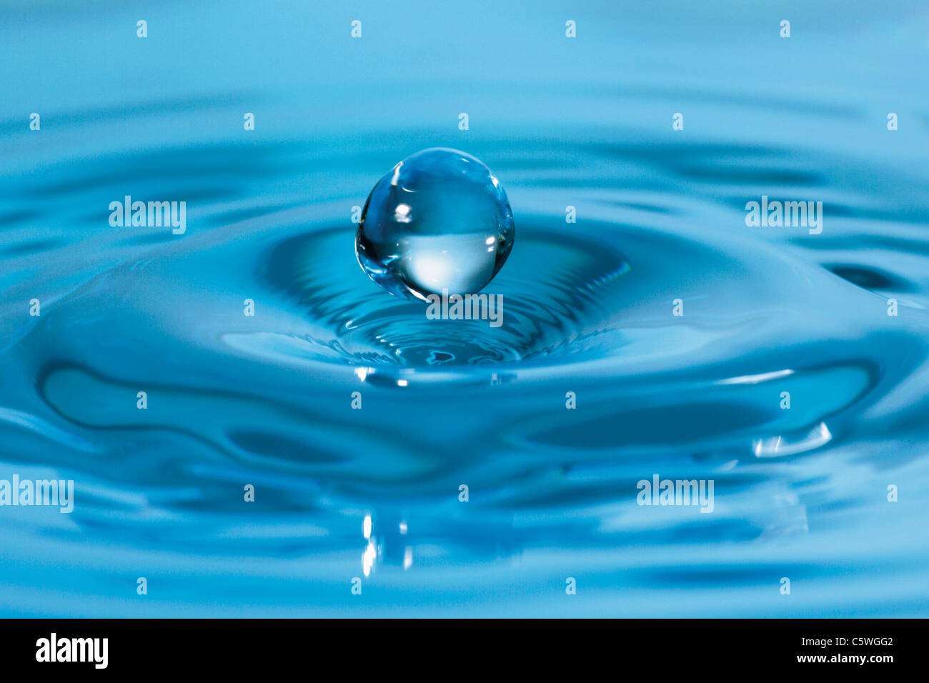 Extreme close up of waterdrop falling in water Stock Photo
