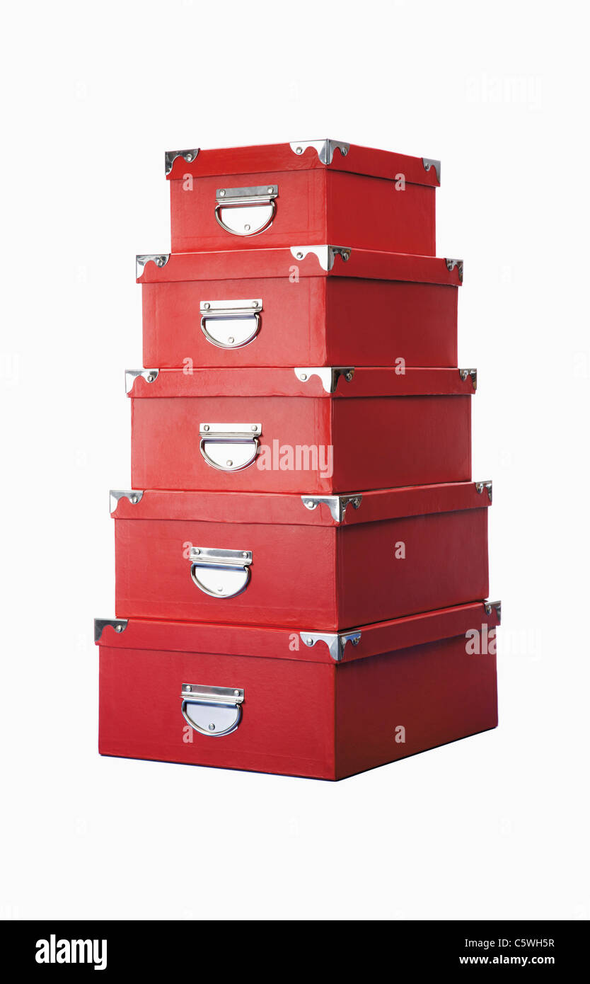 Stack of red storage boxes against white background Stock Photo