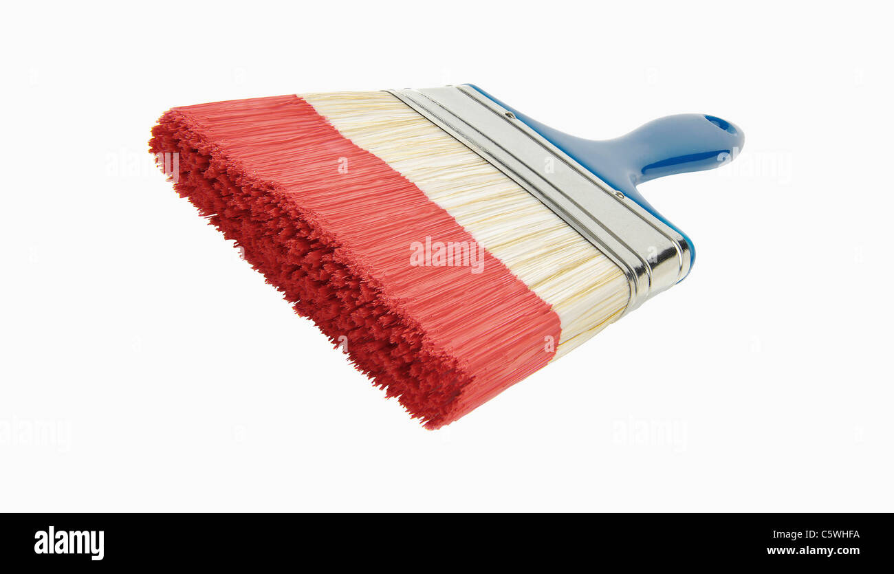 Brush with red paint, close up Stock Photo
