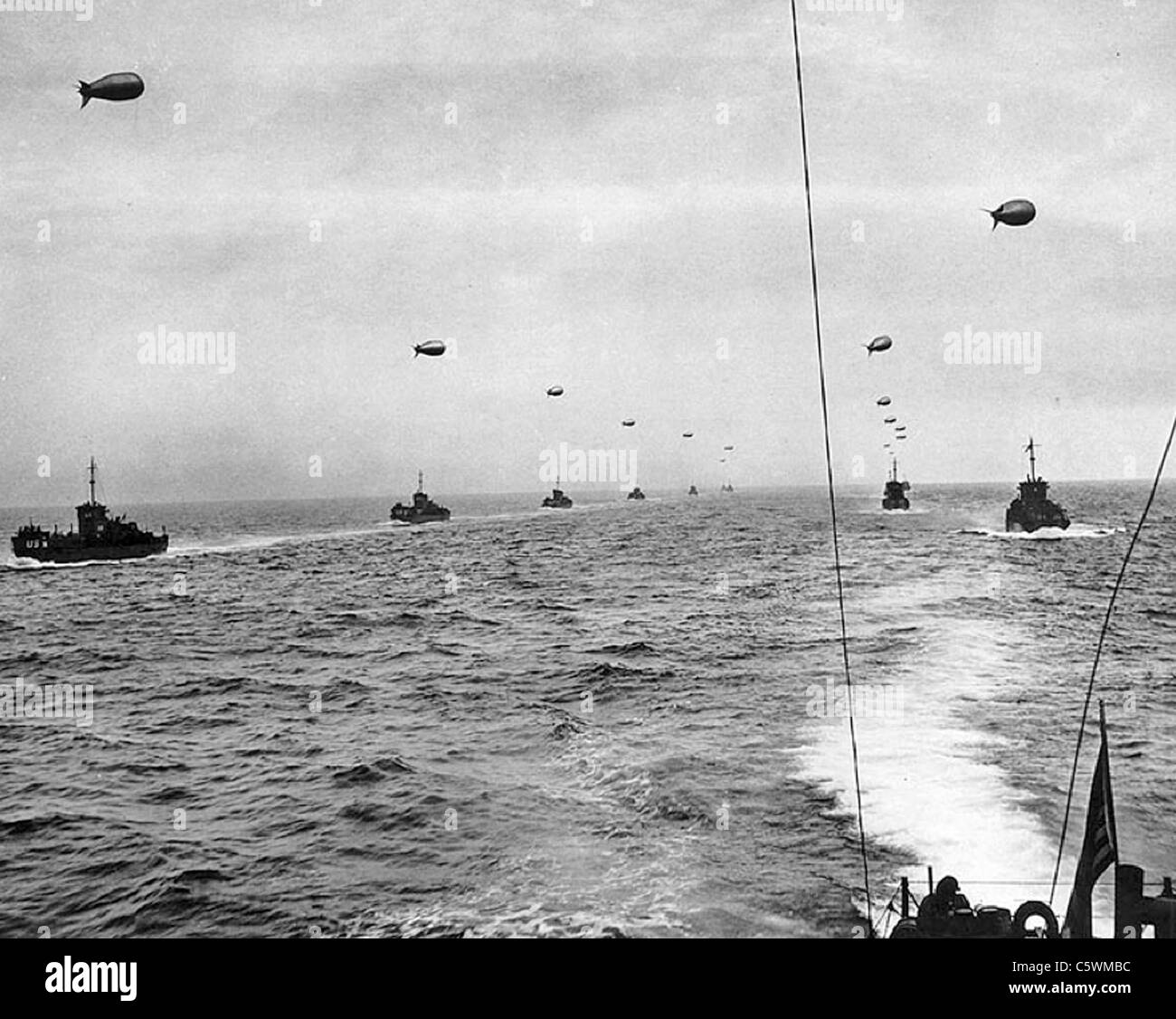 D-DAY 1944 Landing Craft Infantry, Large (LCIL) each towing a protective barrage balloon head for Normandy on 6 June 1944. Stock Photo