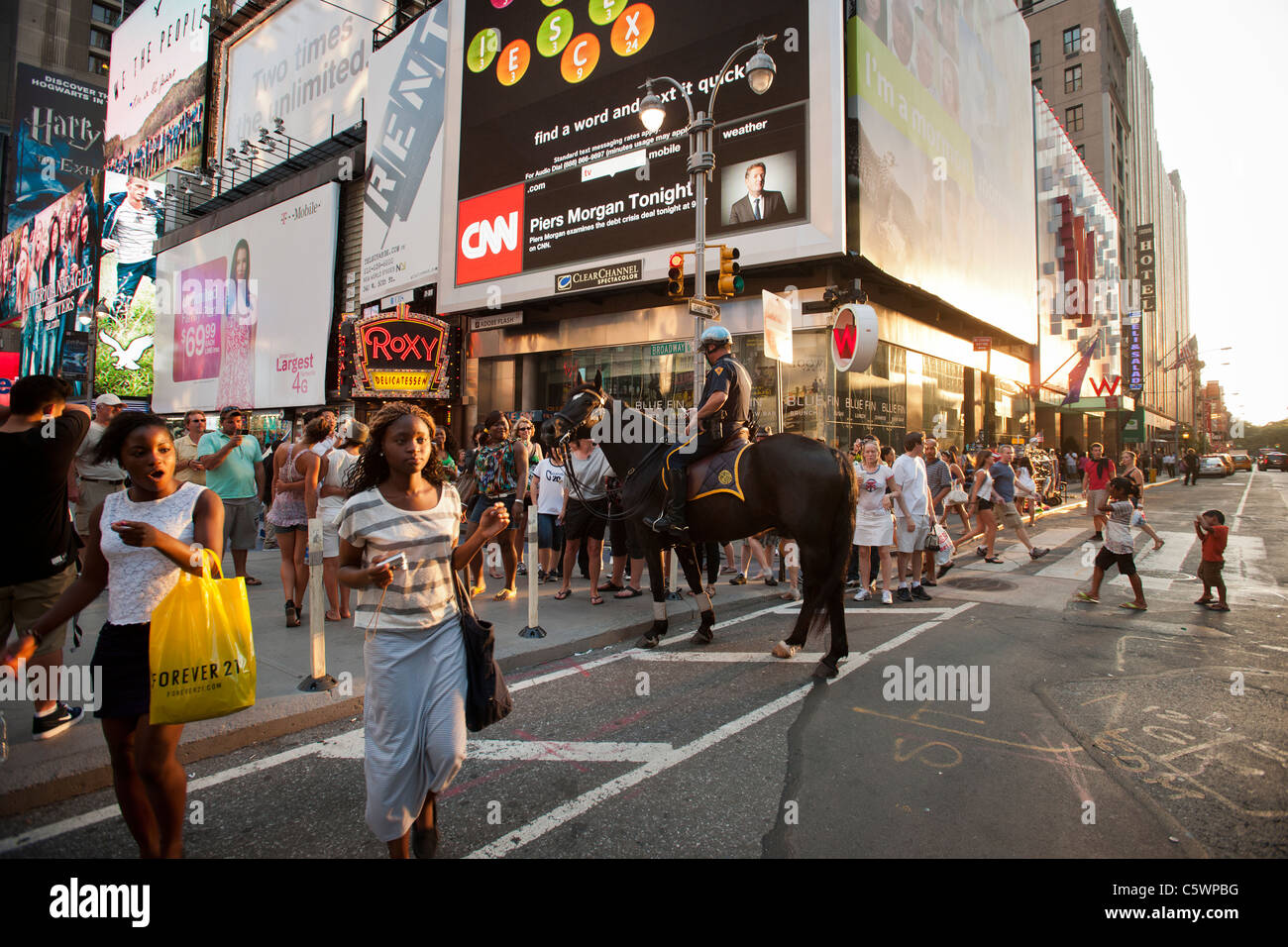A mounted NYPD officer greets tourists in Times Square in New York on ...