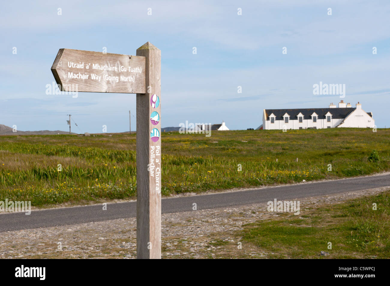A signpost for the Machair Way long distance footpath in front of the Polochar Inn on the Hebridean island of South Uist. Stock Photo