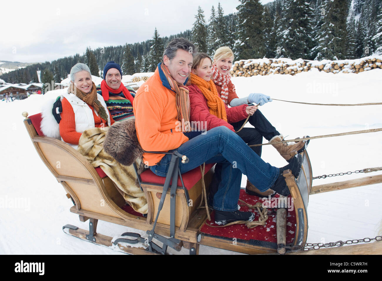 Italy, South Tyrol, Seiseralm, Family riding in sleigh Stock Photo