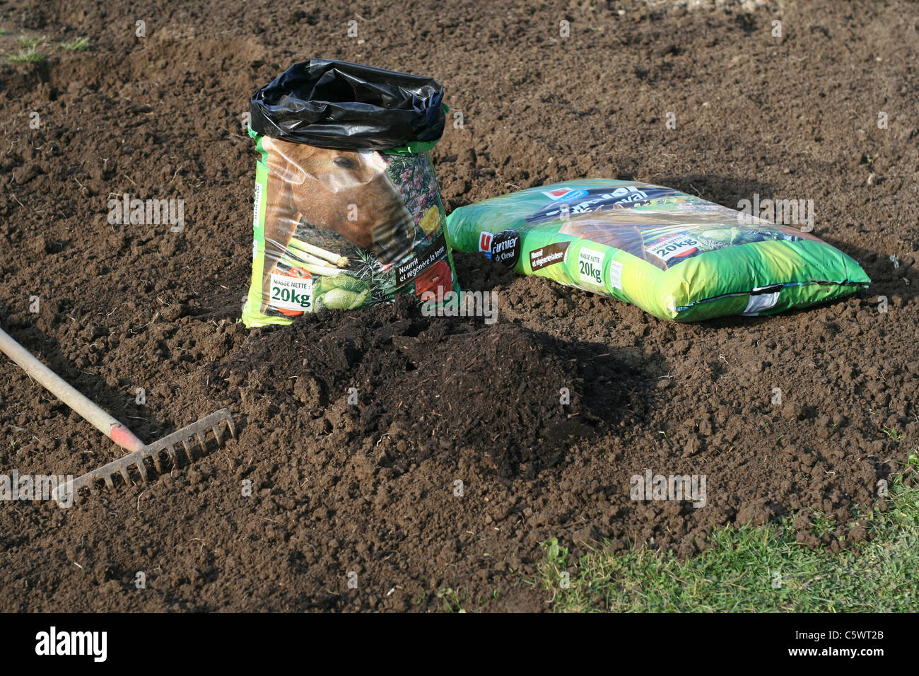 Bags of horse manure in the vegetable garden Stock Photo