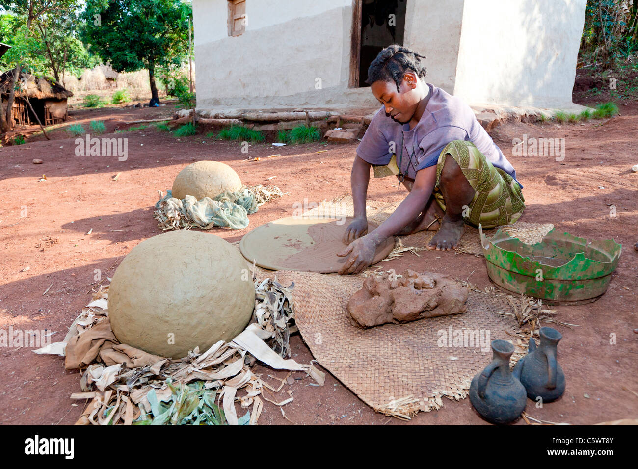An Ari tribeswoman making traditional clay plates and pots at a village ...