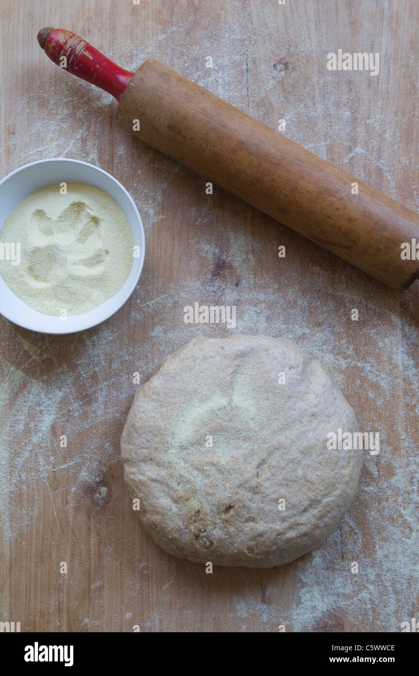Whole wheat pizza dough with rolling pin on board Stock Photo Alamy