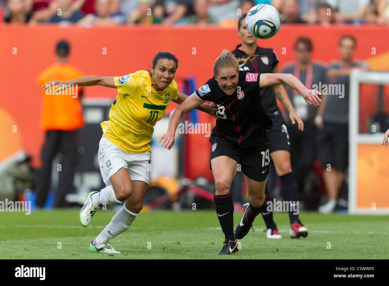 Marta of Brazil (10) and Rachel Buehler of the United States (19) fight for the ball during a FIFA Women's World Cup quarterfinal match July 10, 2011 at Rudolf Harbig Stadium in Dresden, Germany. Editorial use only. No push to mobile device usage. Commercial use prohibited. (Photograph by Jonathan Paul Larsen / Diadem Images) Stock Photo