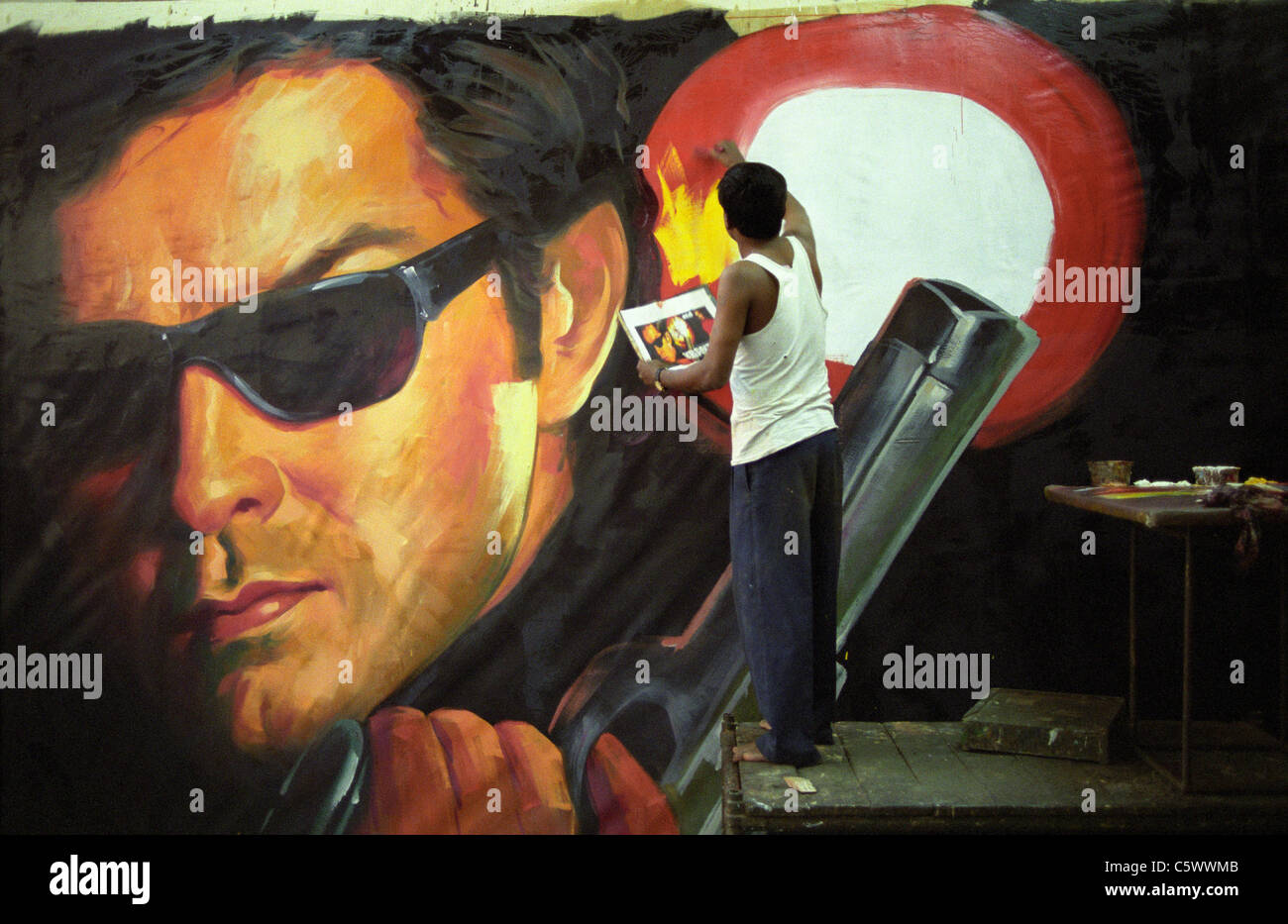 INDIA, Mumbai Bombay, Ellora Arts film hoarder, artists paint large wall posters as advertisement for new Bollywood movie releases at cinemas Stock Photo