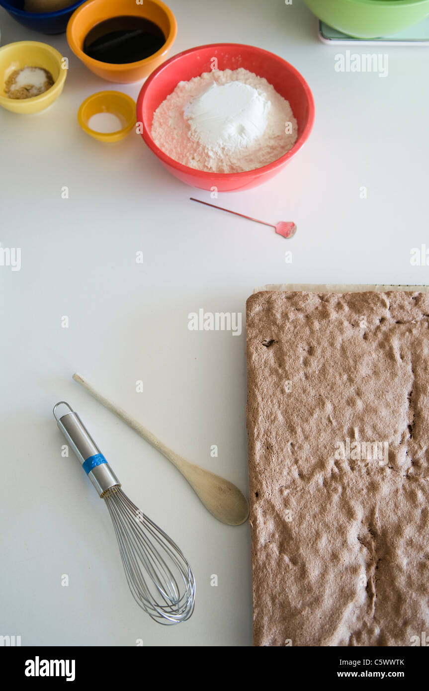 Sponge cake cooling with ginger bread ingredients on counter top Stock