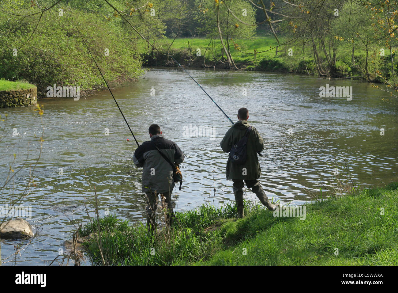 Two anglers along the river, opening of trout fishing, river la Varenne (Orne, Normandy, France