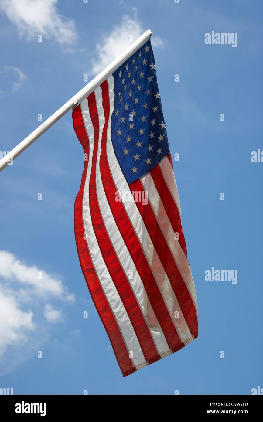 us american flag on flagpole against blue cloudy sky usa Stock Photo