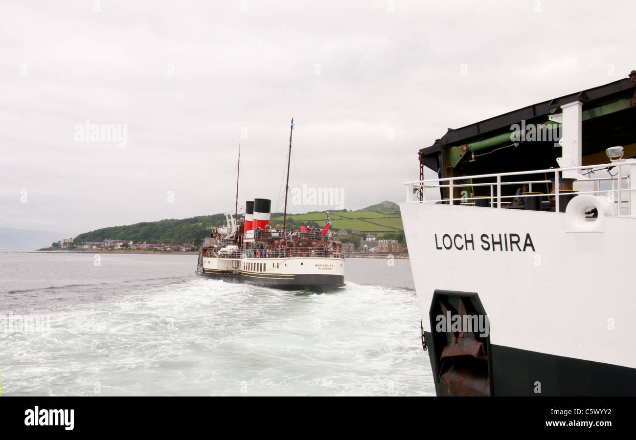 MV Loch Shira at Largs with the paddle streamer Waverly cutting across its path. Stock Photo